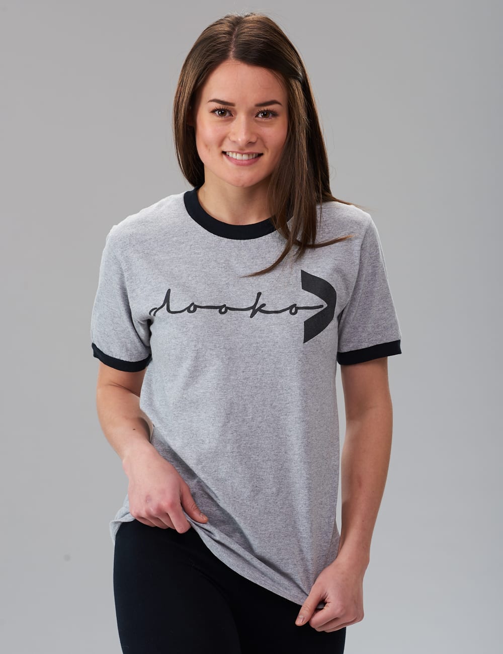 female model wearing the gray ringer t-shirt with the dooko logo covering the chest